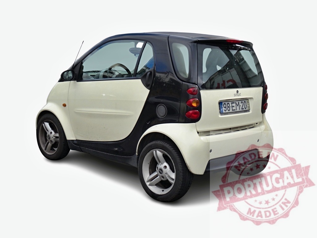 Smart Fortwo Coupe showing its back part on white background | Small city car parked, rear view of a Smart Fortwo Coupe isolated on white - Realized with Pictrs.com