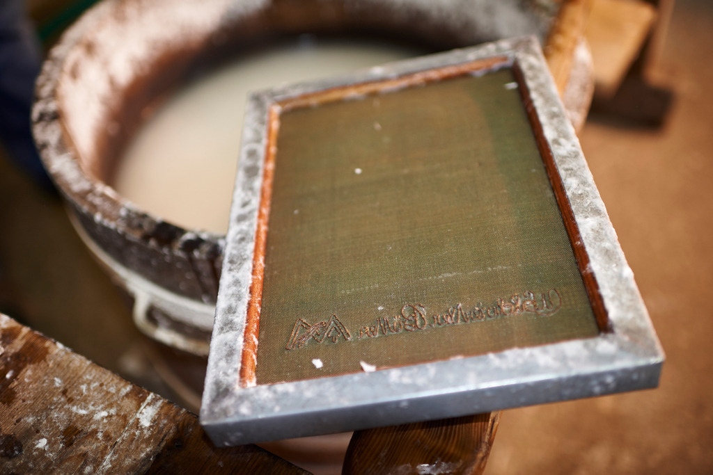 Papiermuehle Moerzinger  | Bad Großpertholz, Austria - April 01, 2016: Papiermuehle Moerzinger; der verdünnte Papierstoff im Bottich mit einem Sieb. - Realisiert mit Pictrs.com