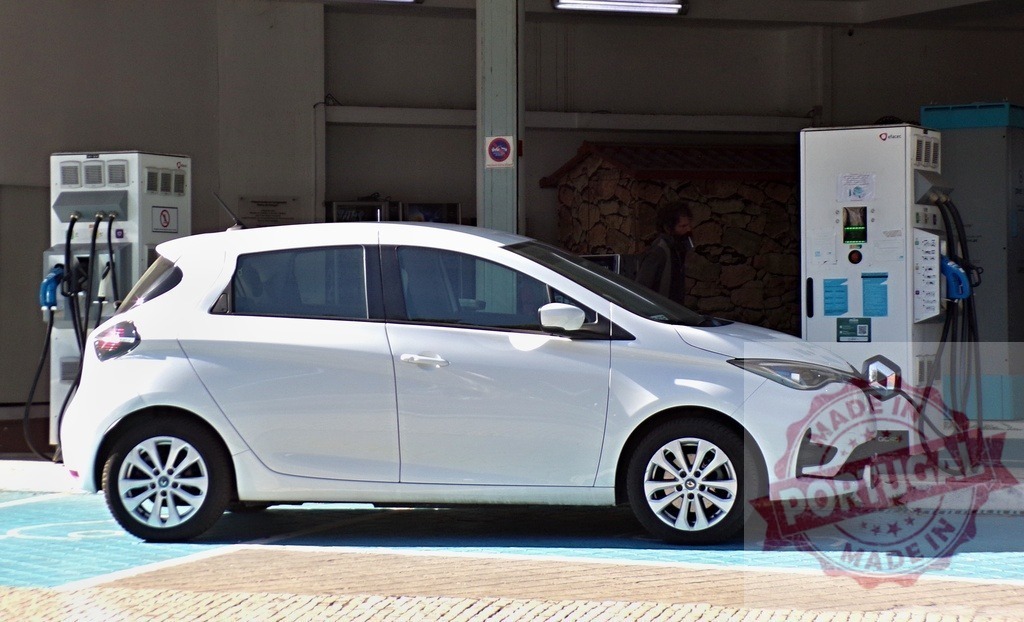 Renault Zoe electric car charging at station | White Renault Zoe electric car charging at a public station, symbolizing sustainable energy - Realisiert mit Pictrs.com