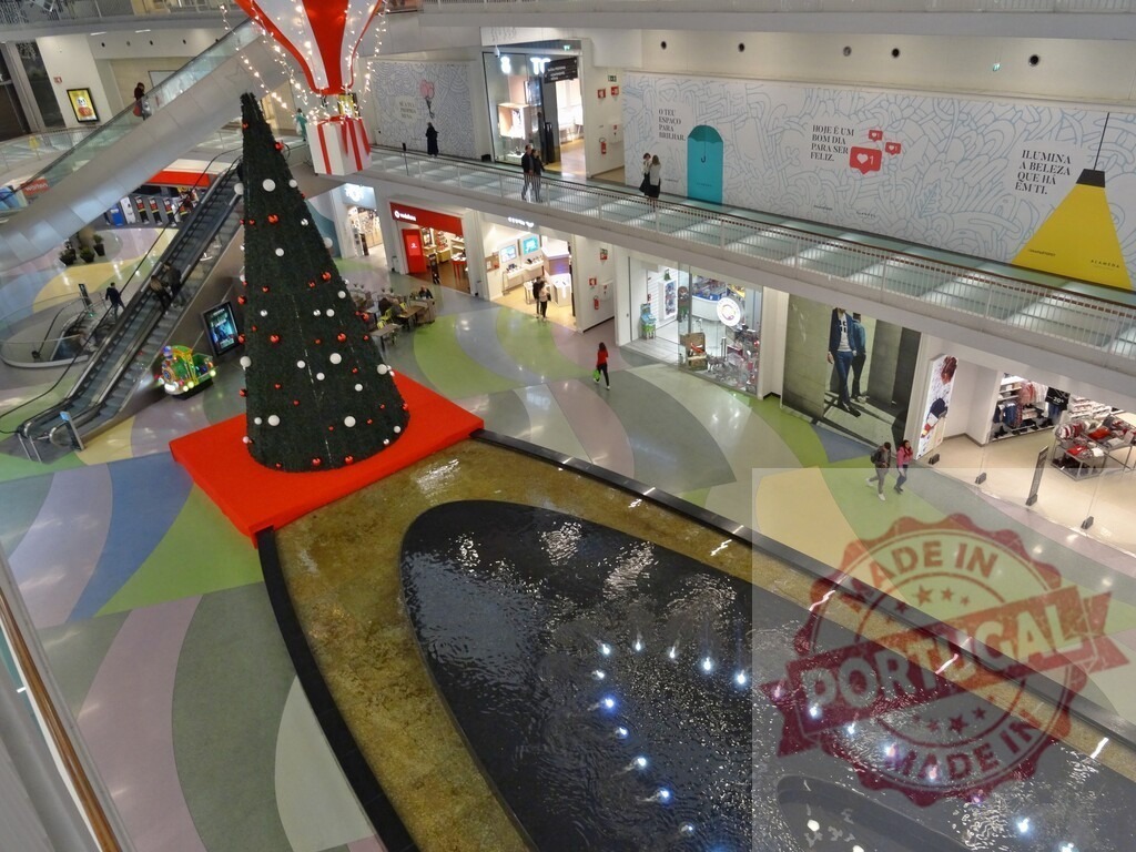 Shopping mall decorated for Christmas holidays with fountain | Large shopping mall interior with fountain and Christmas tree, preparing for holiday season - Realized with Pictrs.com
