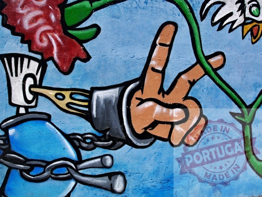 Graffiti art showing peace hand gesture breaking chains | Hand making peace sign, pushing away chains binding a spray can, with a flower and vine - Realized with Pictrs.com