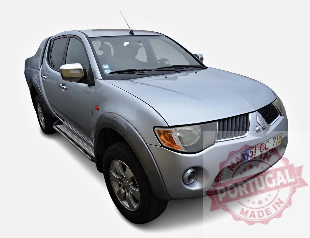 Mitsubishi L200 pickup truck standing on white background | Silver Mitsubishi L200 pickup truck standing on white background in studio setting, showcasing its design and features - Realized with Pictrs.com
