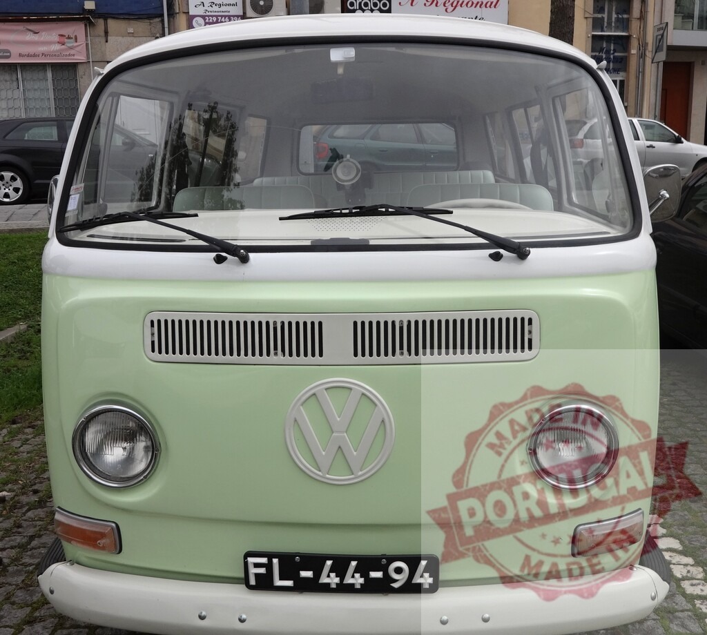 Light green Volkswagen Kombi T2 parked in urban environment | Front view of a light green Volkswagen Kombi T2 parked on a paved street, showcasing its iconic design - Realized with Pictrs.com