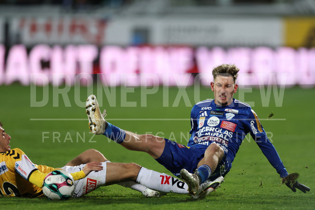TSV Egger Glas Hartberg vs SV Oberbank Ried – Austrian Bundesliga Match | The image shows Ante Bajic (Ried) make a foul on Damjan Kovacevic (Hartberg), at the Bundesliga match TSV Hartberg vs SV Ried at Profertil Arena Hartberg. 22.11.2025