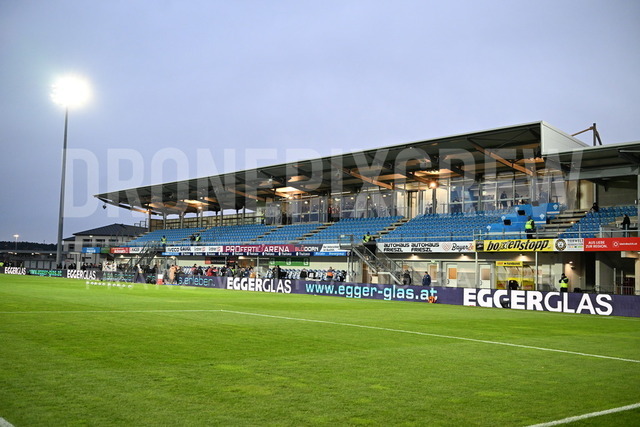 TSV Egger Glas Hartberg vs SV Oberbank Ried – Austrian Bundesliga Match | TSV Egger Glas Hartberg and SV Oberbank Ried. High-intensity match action, tackles, shots on goal, celebrations, fan atmosphere and stadium scenes captured in professional quality. The image shows the new Hartberg Stadion.