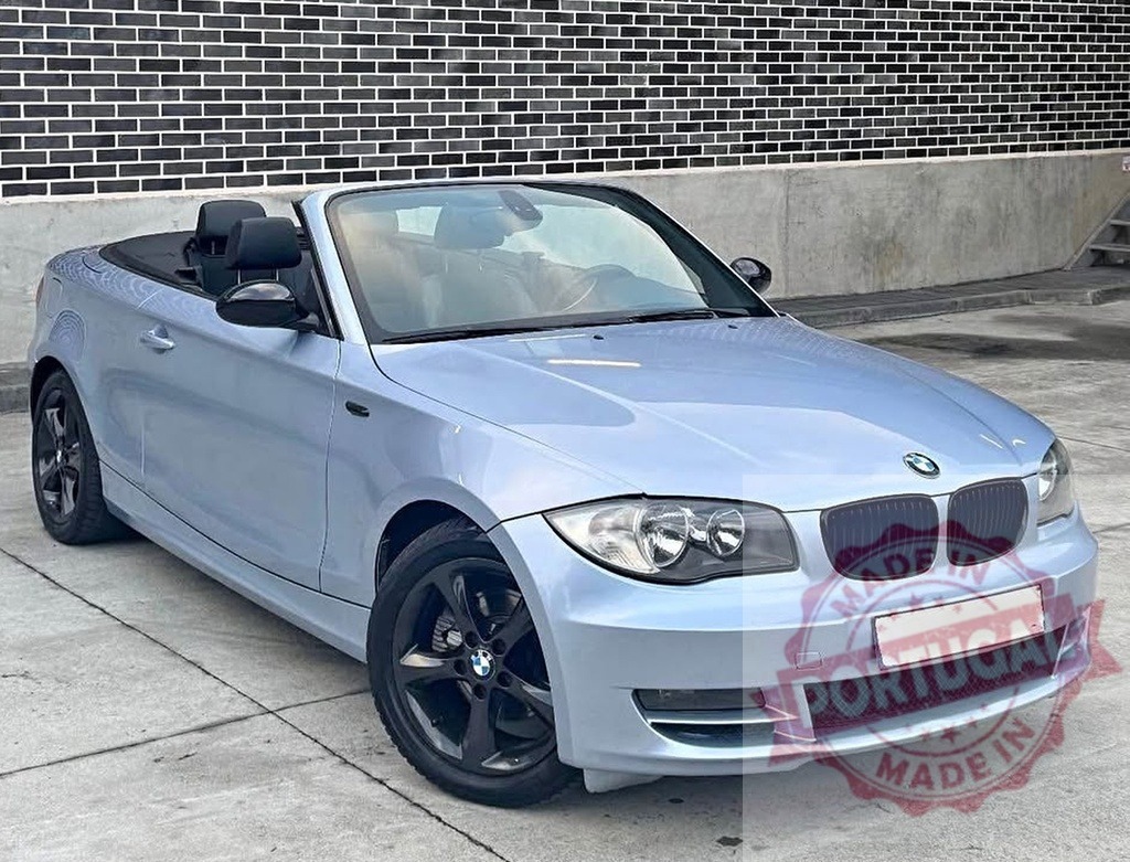 BMW convertible sports car parked on urban street | Light blue BMW 1 Series convertible car parked outdoors against a brick wall - Realisiert mit Pictrs.com