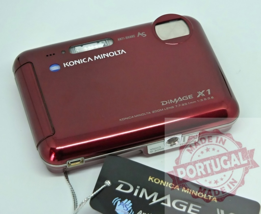 Konica Minolta DIMAGE X1 digital camera technology | Konica Minolta DIMAGE X1 compact digital camera resting on a white surface - Realized with Pictrs.com