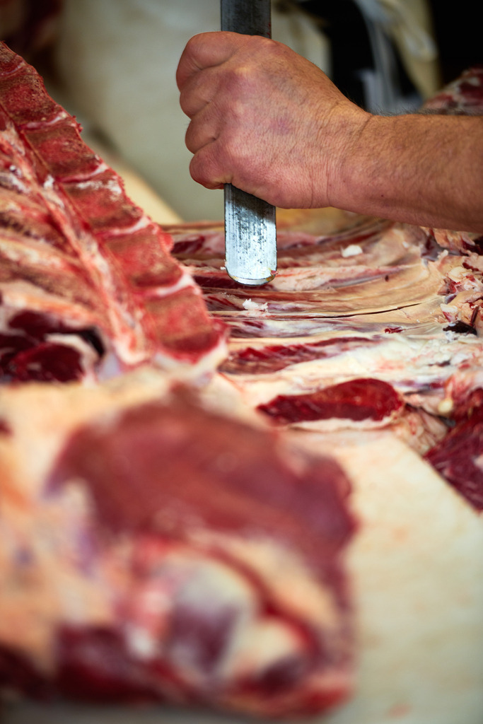 Fleischerei Dormayer | Langenzersdorf, Austria - February 12, 2019: Fleischerei Dormayer; Detail beim bearbeiten eines Fleischstückes. - Realisiert mit Pictrs.com