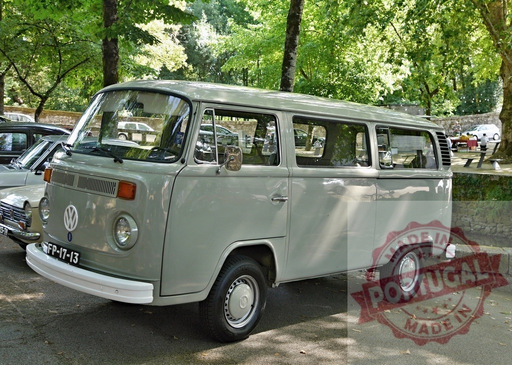 Volkswagen Type 2 vintage van parked in park | Classic Volkswagen T2 Kombi van parked outdoors under green trees - Realized with Pictrs.com