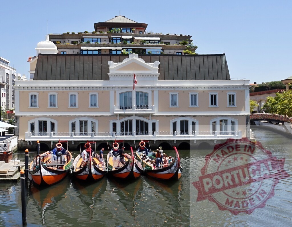 Aveiro moliceiro boats moored on central canal. Aveiro - Portugal | Traditional moliceiro boats waiting for tourists on a canal in Aveiro, Portugal - Realized with Pictrs.com