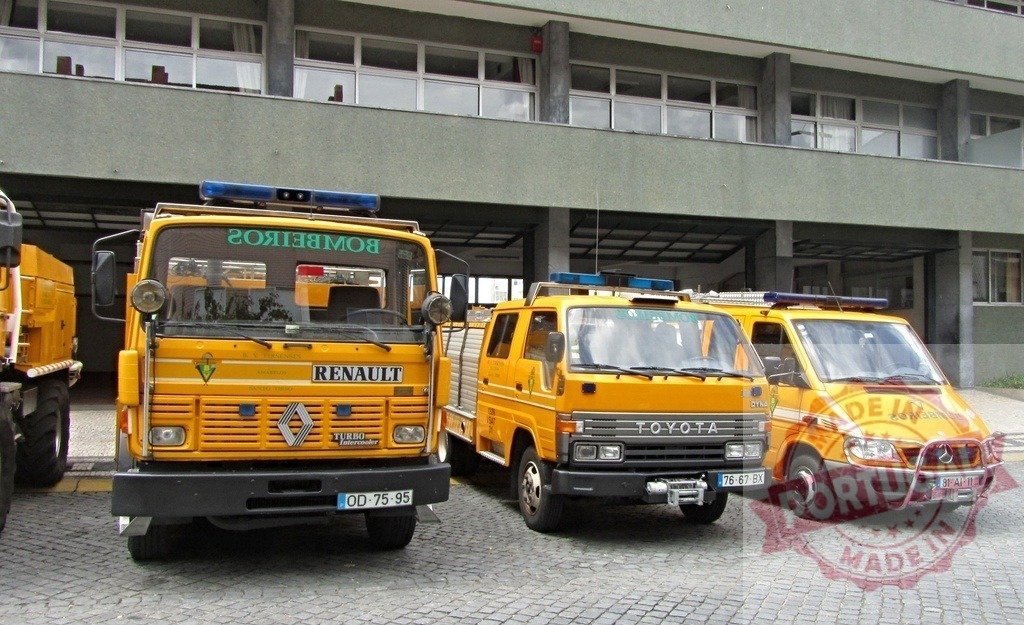 Yellow fire and rescue trucks parked at station | Yellow fire trucks from Bombeiros department parked outside a fire station - Realized with Pictrs.com