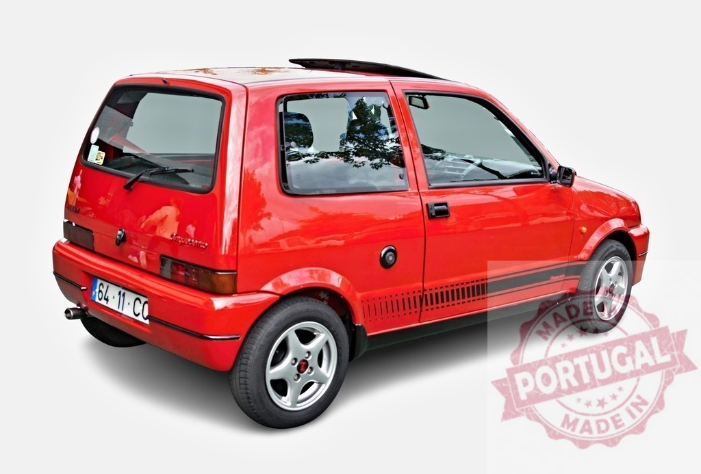 Red Fiat Cinquecento hatchback parked isolated on white | Red Fiat Cinquecento hatchback isolated on white background showing rear three-quarter view - Realized with Pictrs.com