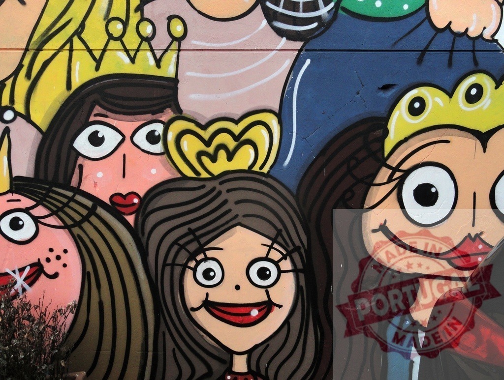 Colorful street art mural displaying cartoon princess characters | Urban wall featuring vibrant cartoon faces of women wearing crowns - Realized with Pictrs.com