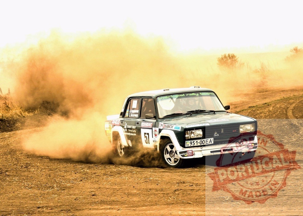 Lada rally car drifting on a dusty gravel road | Rally car kicking up a cloud of dust while speeding on a dirt track - Realized with Pictrs.com