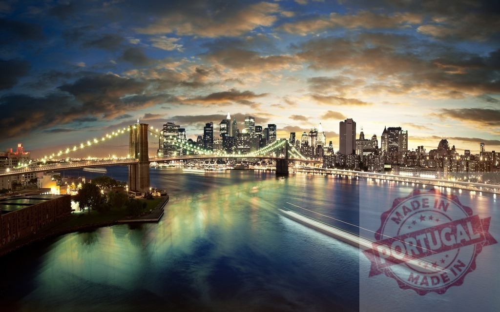 New York City Brooklyn Bridge and Manhattan skyline at sunset | Brooklyn Bridge spanning the East River with the illuminated Manhattan cityscape at dusk - Realized with Pictrs.com