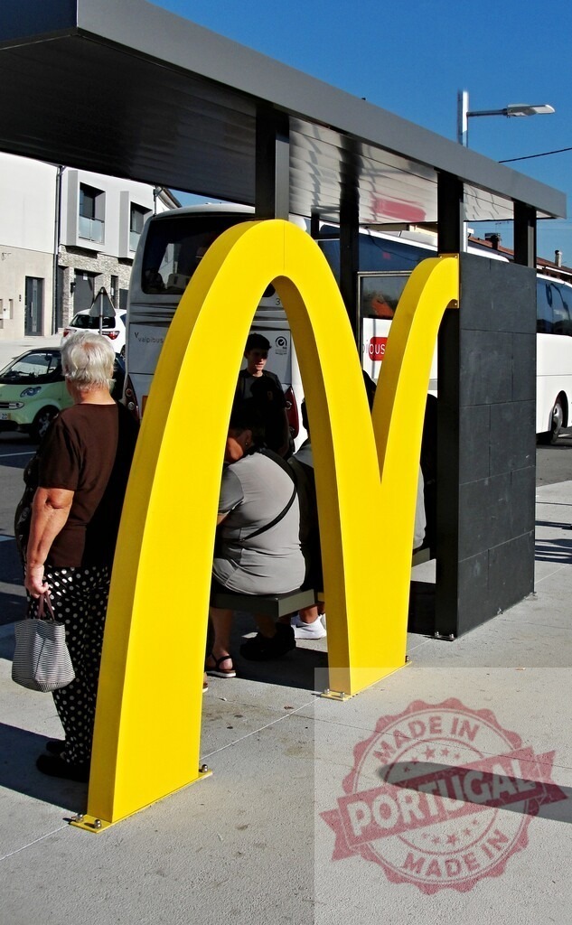 McDonald's Golden Arches bus stop on urban street | People waiting for a bus at a commercial themed bus stop on a sunny day - Realized with Pictrs.com