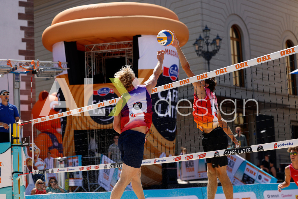 Obi BeachTour 2026 - Basel | BASEL, SWITZERLAND - JULY 18: JACOB HEJLSVIG PETERSEN (DEN) attack / spike against DANIEL ALLEMANN (SUI) block during the Obi BeachTour 2026 match between ALLEMANN / LEFFLER (SUI) and MASSEREY / SCHNEGG (SUI) at Barfüsserplatz on July 18, 2026 in Basel, Switzerland. - Realisiert mit Pictrs.com