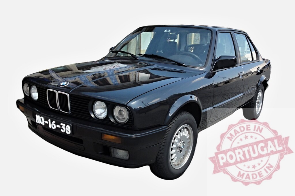 Black BMW E30 Reflecting a Building on its Shining Hood | Classic BMW E30 reflecting a building on its polished hood, showcasing its timeless design and elegance - Realized with Pictrs.com