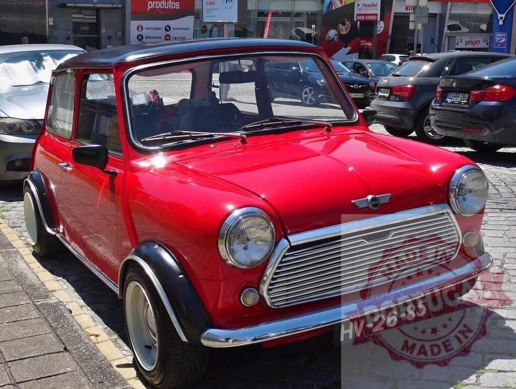 Classic Red Mini Cooper parked on a cobblestone street | Shiny red Mini Cooper parked on a city street, showcasing its timeless design - Realized with Pictrs.com