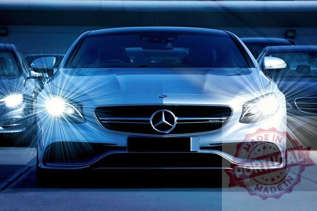Mercedes-Benz luxury sedan with bright headlights at night | Mercedes-Benz E-Class sedan with illuminated headlights in a parking lot - Realized with Pictrs.com
