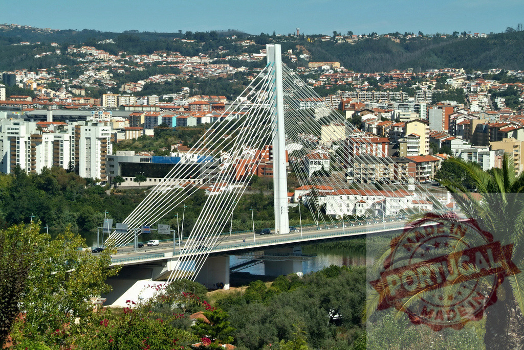 Rainha Santa Isabel Bridge spanning Mondego river in Coimbra | Modern cable-stayed bridge connecting areas of Coimbra city, Portugal, with river and buildings - Realized with Pictrs.com
