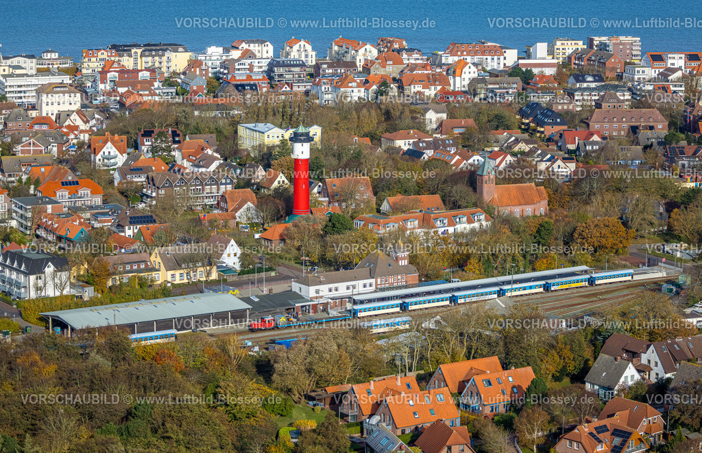 Friesland251106278Wangerooge | Luftbild, rot-weißer Alter Leuchtturm und Inselmuseum im Zentrum, DB-Bahnhof und Inselsbahn,  evangelisch-lutherische Nikolai-Kirche, Wohngebiet und Blick zur Nordsee, Wangerooge, Norddeutschland, Ostfriesland, Niedersachsen, Deutschland