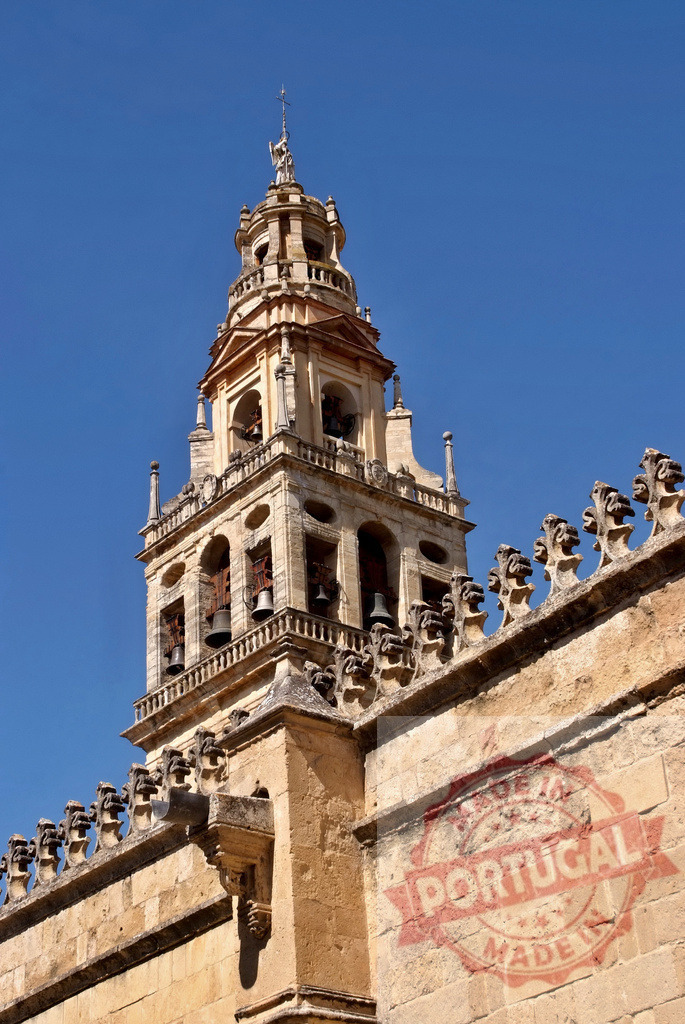 Bell tower of the Mosque-Cathedral of Córdoba, Spain. Spain - Cordoba | Bell tower of the historic Mosque-Cathedral of Córdoba standing against a clear blue sky - Realisiert mit Pictrs.com
