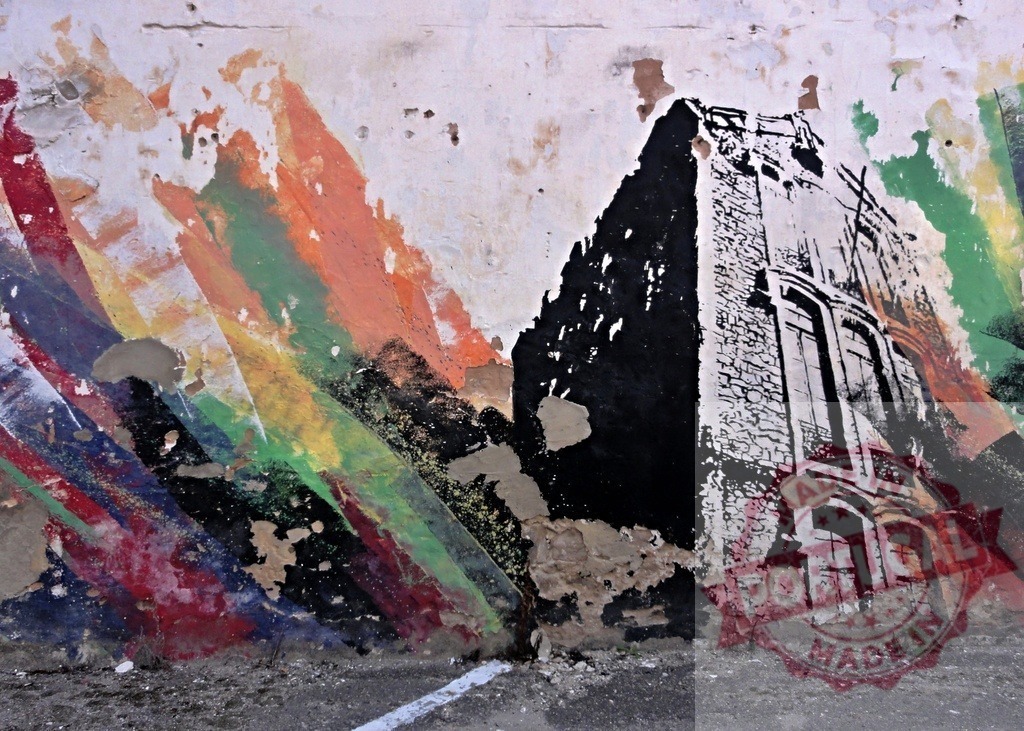 Urban graffiti building stencil on decaying rainbow wall | Abstract street art mural featuring a building stencil and colorful peeling paint on an old wall - Realized with Pictrs.com