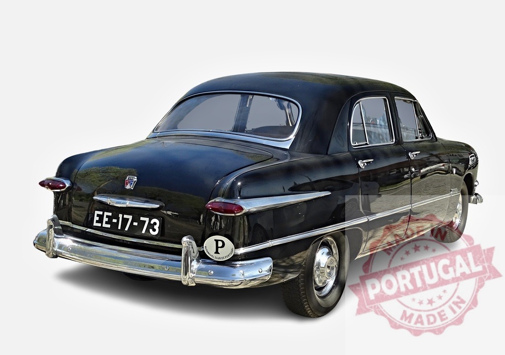 Black Ford Custom Deluxe Sedan Parked on White Background | Classic Ford Custom Deluxe sedan showcasing its timeless design and elegant black finish - Realized with Pictrs.com