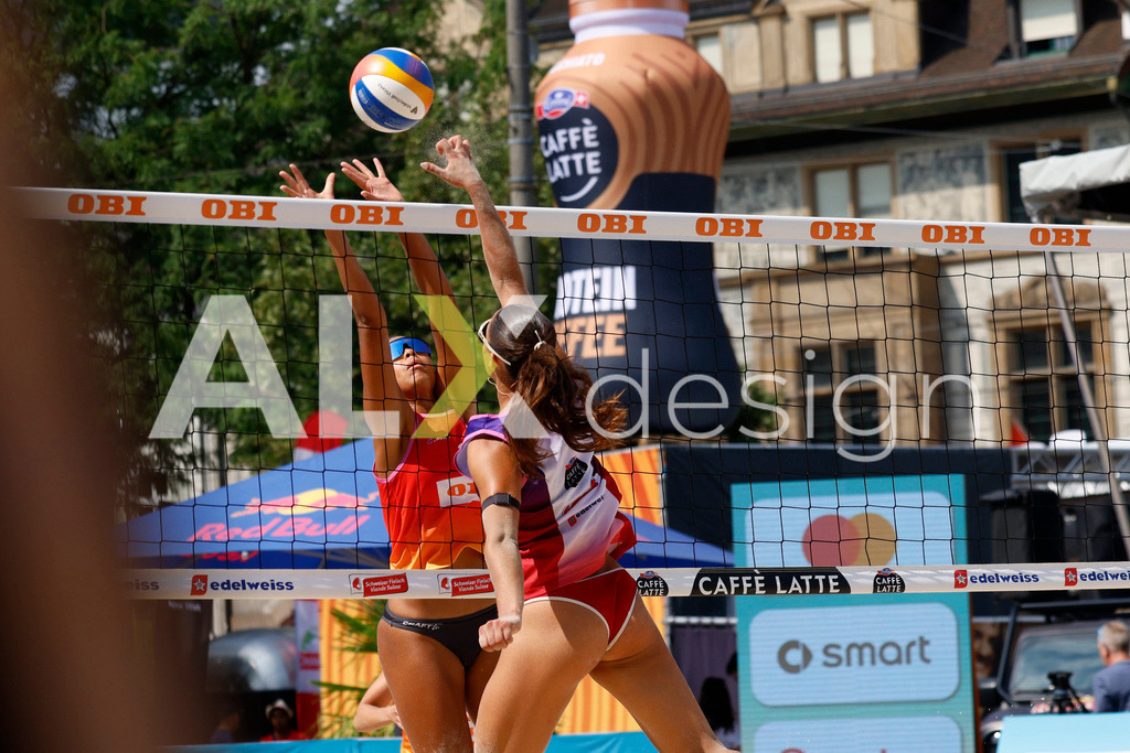 Obi BeachTour 2026 - Basel | BASEL, SWITZERLAND - JULY 19: ZOÉ FLÜCKIGER (SUI) attack / spike against ELENA CSONTOS (SUI) block during the Obi BeachTour 2026 match between CSONTOS / DEECKE (SUI) and FLÜCKIGER / DEMIERRE (SUI) at Barfüsserplatz on July 19, 2026 in Basel, Switzerland. - Realisiert mit Pictrs.com