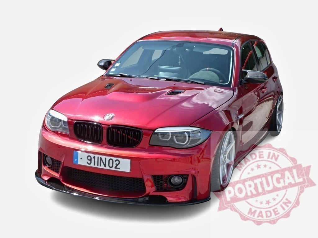 Customized BMW 1 Series showcasing tuning modifications | Red tuned BMW 1 series exhibiting aftermarket parts, including body kit, hood vents, and alloy wheels - Realized with Pictrs.com