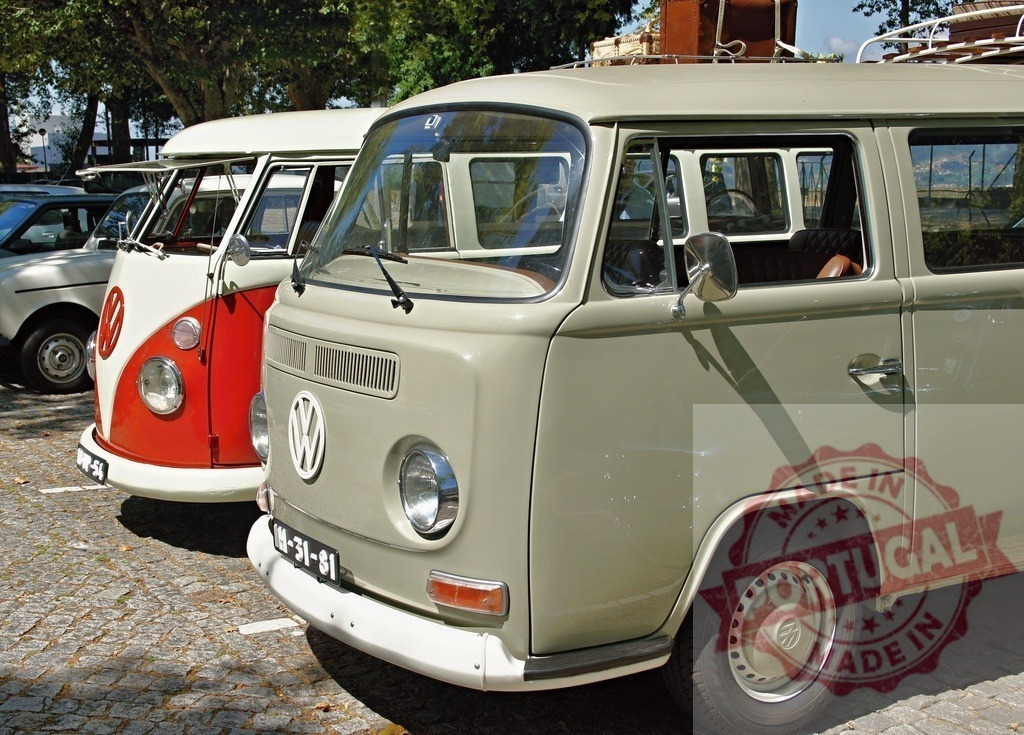 Two classic Volkswagen Kombi Type 2 vans parked in a cobbled street | Two vintage Volkswagen vans, also known as Kombis, parked on a cobblestone street, evoking a sense of nostalgia and classic automotive design - Realized with Pictrs.com