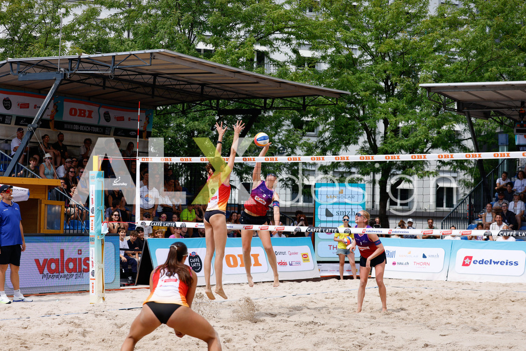 Obi BeachTour 2026 - Basel | BASEL, SWITZERLAND - JULY 17: ANJA GÄHWILER (SUI) attack / spike against NADINE DEMIERRE (SUI) block during the Obi BeachTour 2026 match between FLÜCKIGER / DEMIERRE (SUI) and EUGSTER / GÄHWILER (SUI) at Barfüsserplatz on July 17, 2026 in Basel, Switzerland. - Realisiert mit Pictrs.com