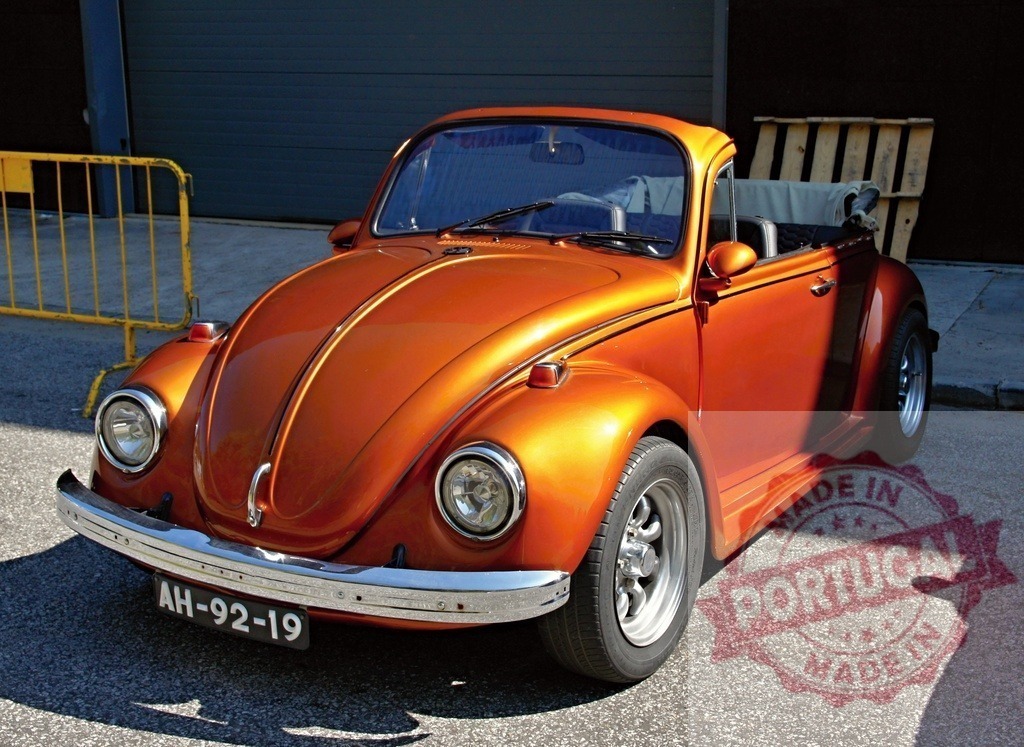 Shiny orange Volkswagen Beetle parked in the sun | Customized orange Volkswagen Beetle convertible parked in the sun - Realized with Pictrs.com