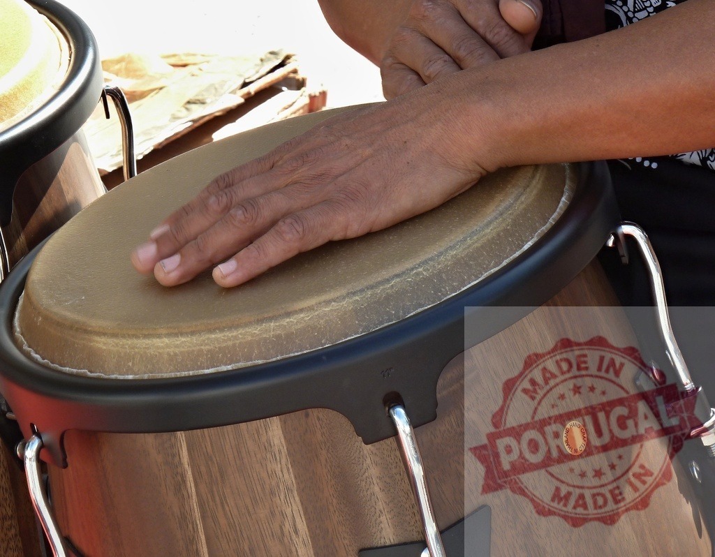 Musician playing conga drum during a concert | Close-up of hands playing a conga drum during a live musical performance - Realized with Pictrs.com