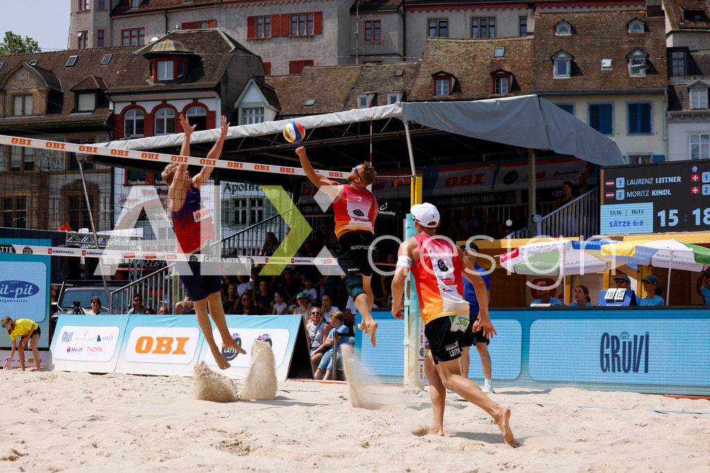 Obi BeachTour 2026 - Basel | BASEL, SWITZERLAND - JULY 19: MORITZ KINDL (AUT) attack / spike against MATHIS KÄLIN (SUI) block during the Obi BeachTour 2026 match between LEITNER / KINDL (AUT) and BREER / KÄLIN (SUI) at Barfüsserplatz on July 19, 2026 in Basel, Switzerland. - Realisiert mit Pictrs.com