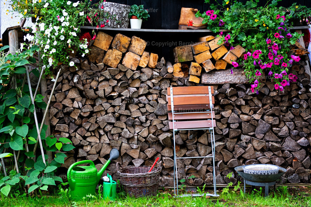 Im Garten | Hausgarten mit Holzstapel und Gartenwerkzeugen. - Realisiert mit Pictrs.com