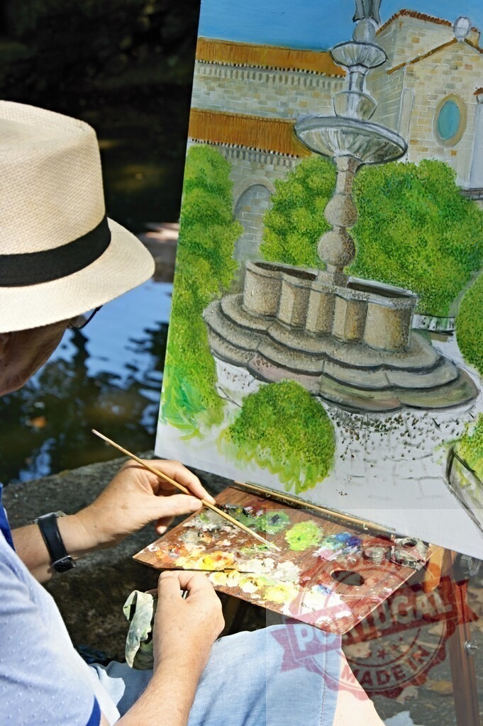 Artist painting fountain scene outdoors creating art | Artist painting a fountain and garden scene on canvas with a palette and brush outdoors - Realized with Pictrs.com