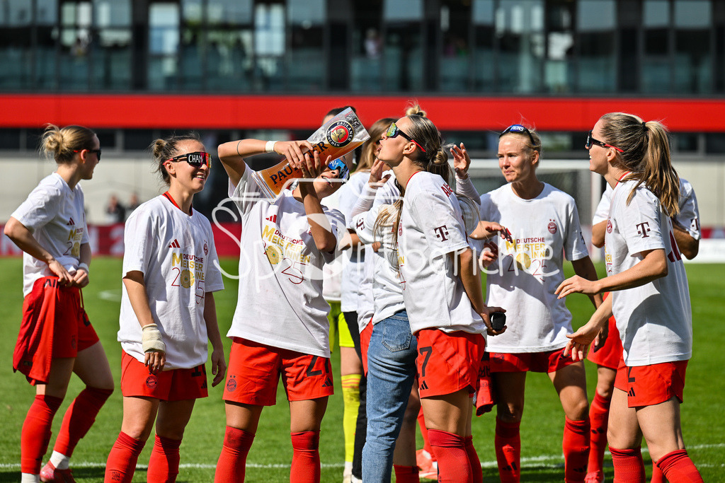 FC Bayern München - SC Freiburg | Die Spielerinnen des FC Bayern feiern die Meisterschaft nach dem Heimsieg gegen den SC Freiburg / Frauen Bundesliga: FC Bayern Muenchen - SC Freiburg, FC Bayern Campus am 27.04.2025 / Arianna CARUSO (FC Bayern Muenchen Frauen 27) gibt Klara BUEHL (FCB #17) einen Schluck auf dem Paulaner Bierkrug / Bierglas