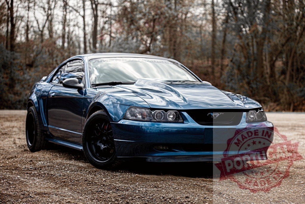 Blue Ford Mustang sports car parked outdoors | Blue Ford Mustang muscle car with a custom hood standing on a gravel road - Realized with Pictrs.com