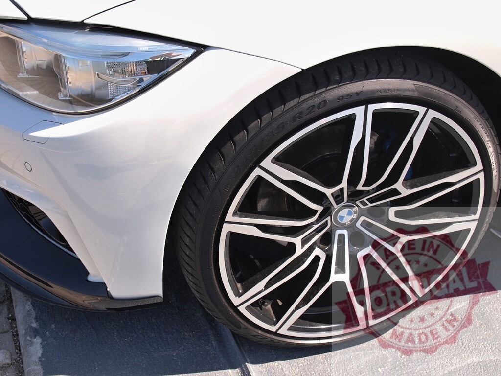 BMW modern design featuring wheel and headlight | Close up view of a white BMW car's alloy wheel and headlight - Realisiert mit Pictrs.com