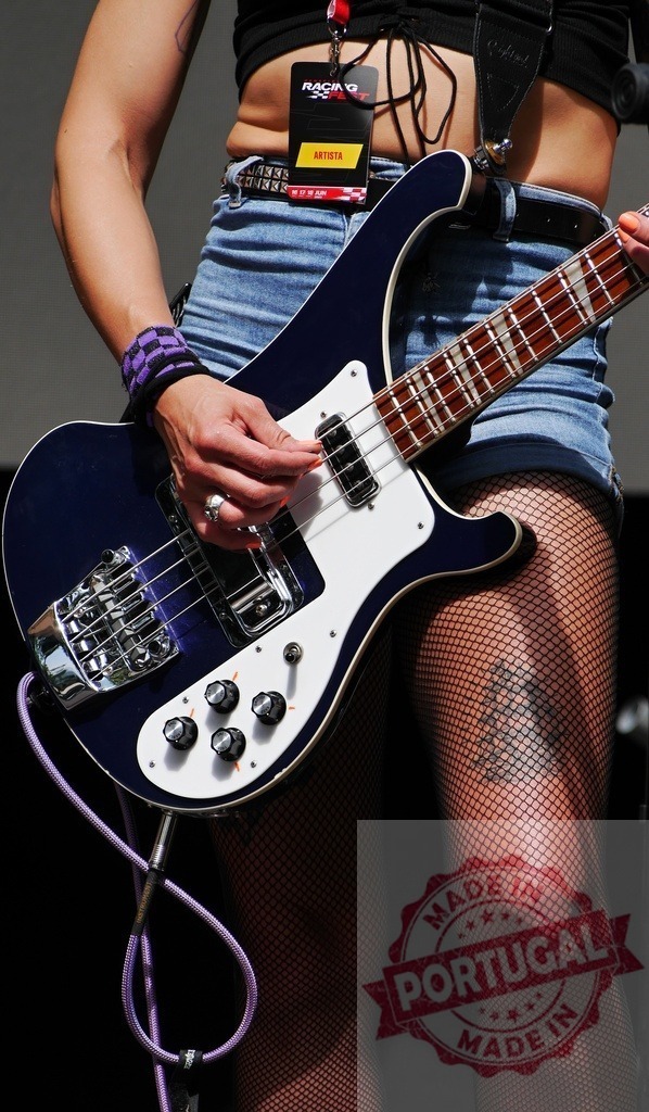 Woman playing Rickenbacker bass guitar at festival concert | Musician playing electric bass guitar during a live rock music performance - Realisiert mit Pictrs.com