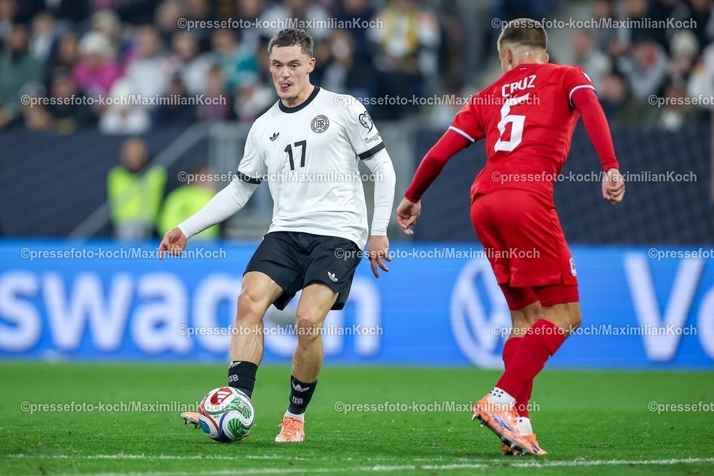 DFB10102501097 | 10.10.2025, Fußball, Länderspiel, Deutschland - Luxemburg, UEFA WM-Qualifikation, 2025/2026, Gruppe A, PreZero Arena in Sinsheim: Florian Wirtz (GER #17) im Zweikampf gegen  Alessio Curci (LUX #05) DFB regulations prohibit any use of photographs as image sequences and or quasi-video.