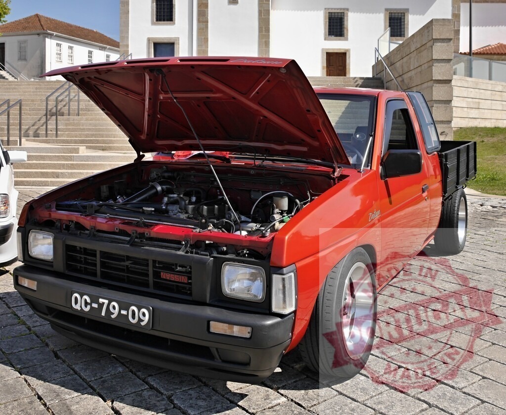 Red Nissan Datsun pickup truck with open hood | Red customized Nissan Datsun pickup truck with open hood displaying engine at car show - Realisiert mit Pictrs.com