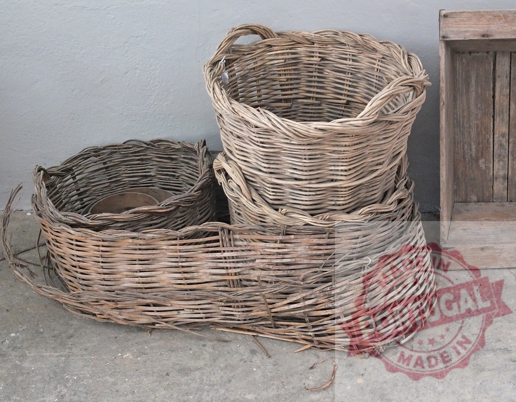 Weathered wicker baskets on concrete floor with wood | Weathered wicker baskets standing on a concrete floor next to a vintage wooden box - Realized with Pictrs.com