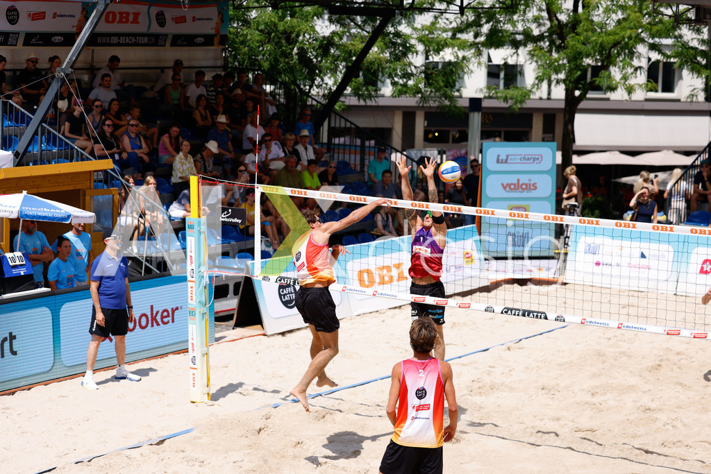 Obi BeachTour 2026 - Basel | BASEL, SWITZERLAND - JULY 17: DANIEL ALLEMANN (SUI) attack / spike against NOAH YANNIK ALOIS FURRER (SUI) blocking during the Obi BeachTour 2026 match between ALLEMANN / LEFFLER (SUI) and FURRER / WYMANN (SUI) at Barfüsserplatz on July 17, 2026 in Basel, Switzerland. - Realisiert mit Pictrs.com