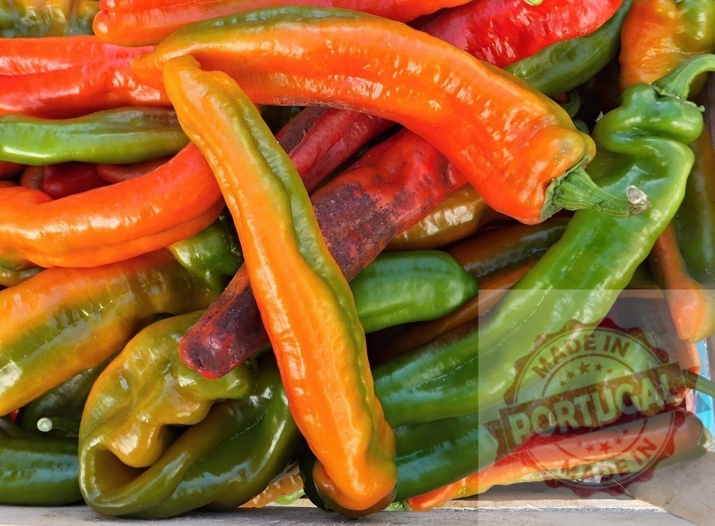 Fresh colorful chili peppers in market display | Various red, orange, and green chili peppers creating a vibrant food background - Realized with Pictrs.com