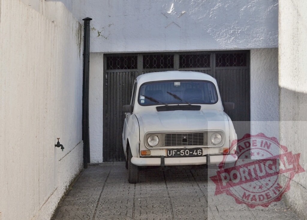 Renault 4 car parked in Portuguese alleyway | White Renault 4 car parked in a narrow traditional Portuguese alleyway with garage door - Realized with Pictrs.com