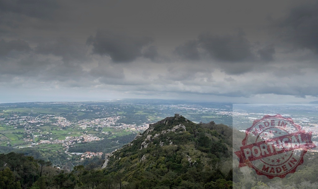 Castelo dos Mouros, Sintra, Portugal, ancient fortress view | Castelo dos Mouros walls standing on a mountaintop overlooking the valley and cityscape under cloudy sky - Realized with Pictrs.com