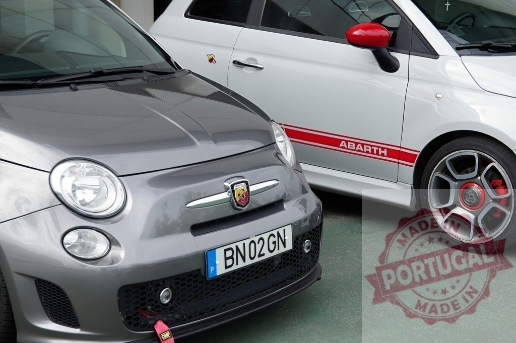 Two Fiat 500 Abarth parked next to each other | Close up of two Fiat 500 Abarth cars parked next to each other showcasing their sporty design - Realized with Pictrs.com